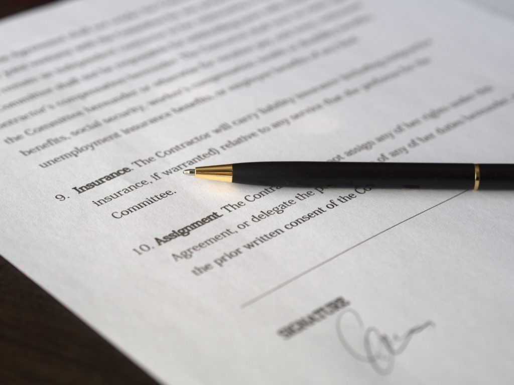 legal contract with pen and signature