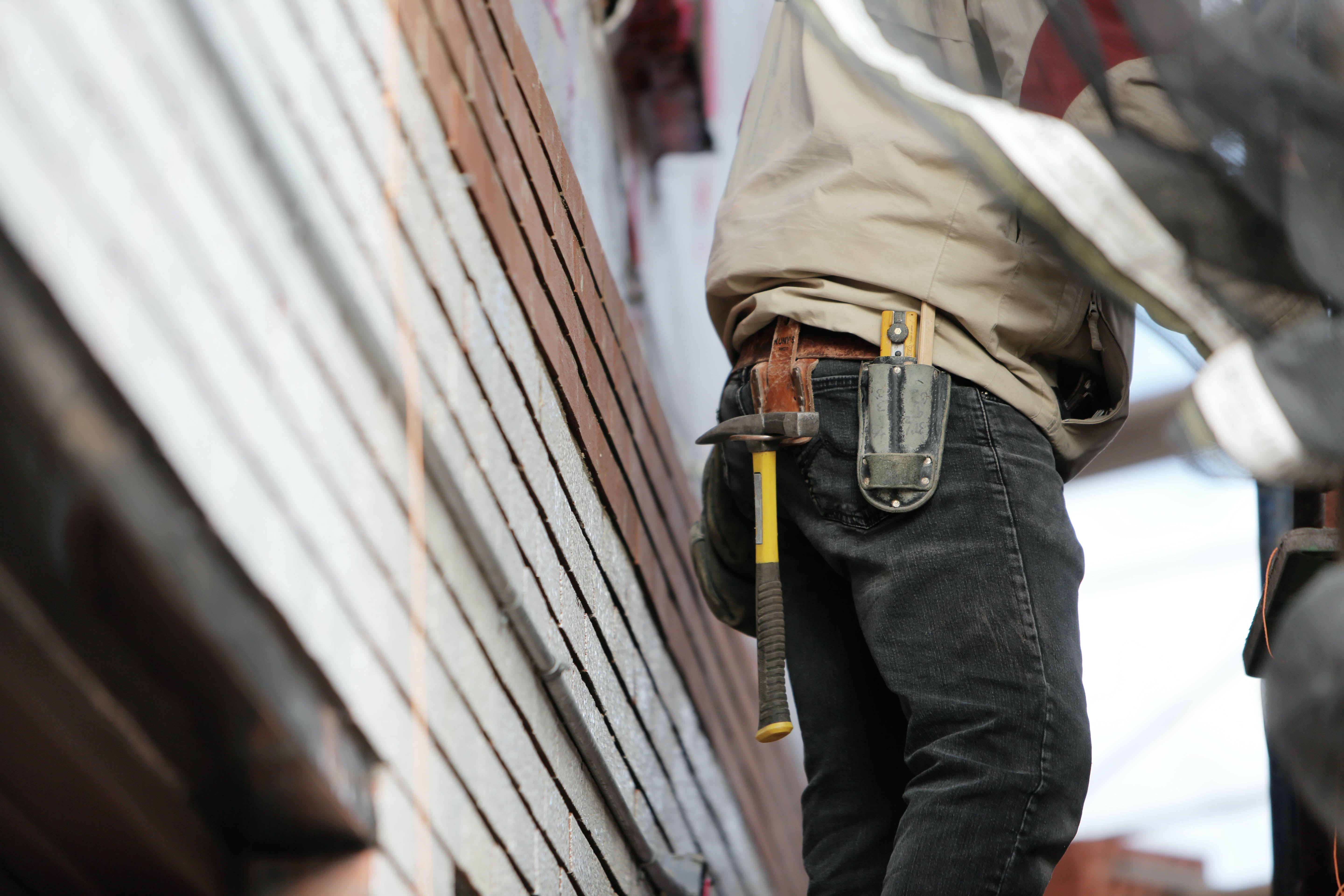 man wearing black denim hammer on holster pants carrying