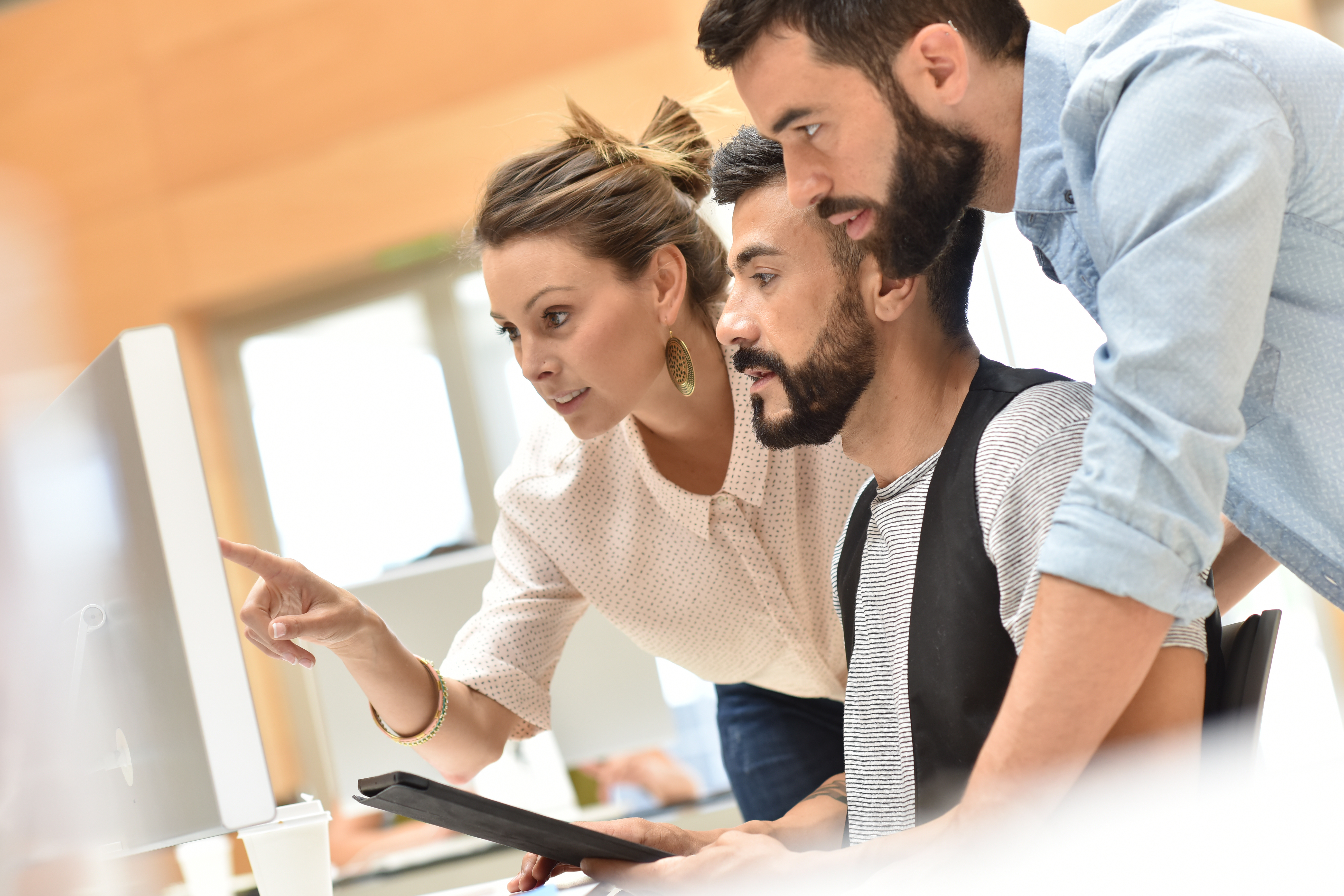 business team meeting in front of desktop